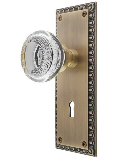 Ovolo Mortise-Lock Set with Ovolo Crystal-Glass Knobs and Keyhole in Antique Brass.